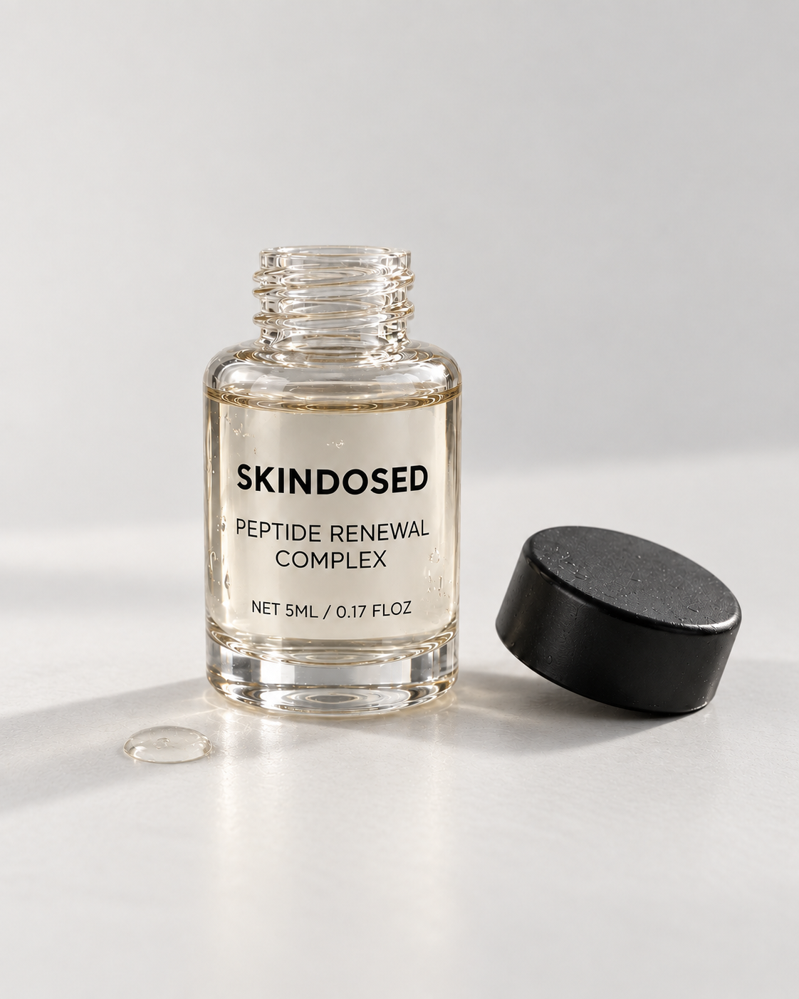 SkinDosed peptide renewal complex serum bottle and applicator on a stone vanity